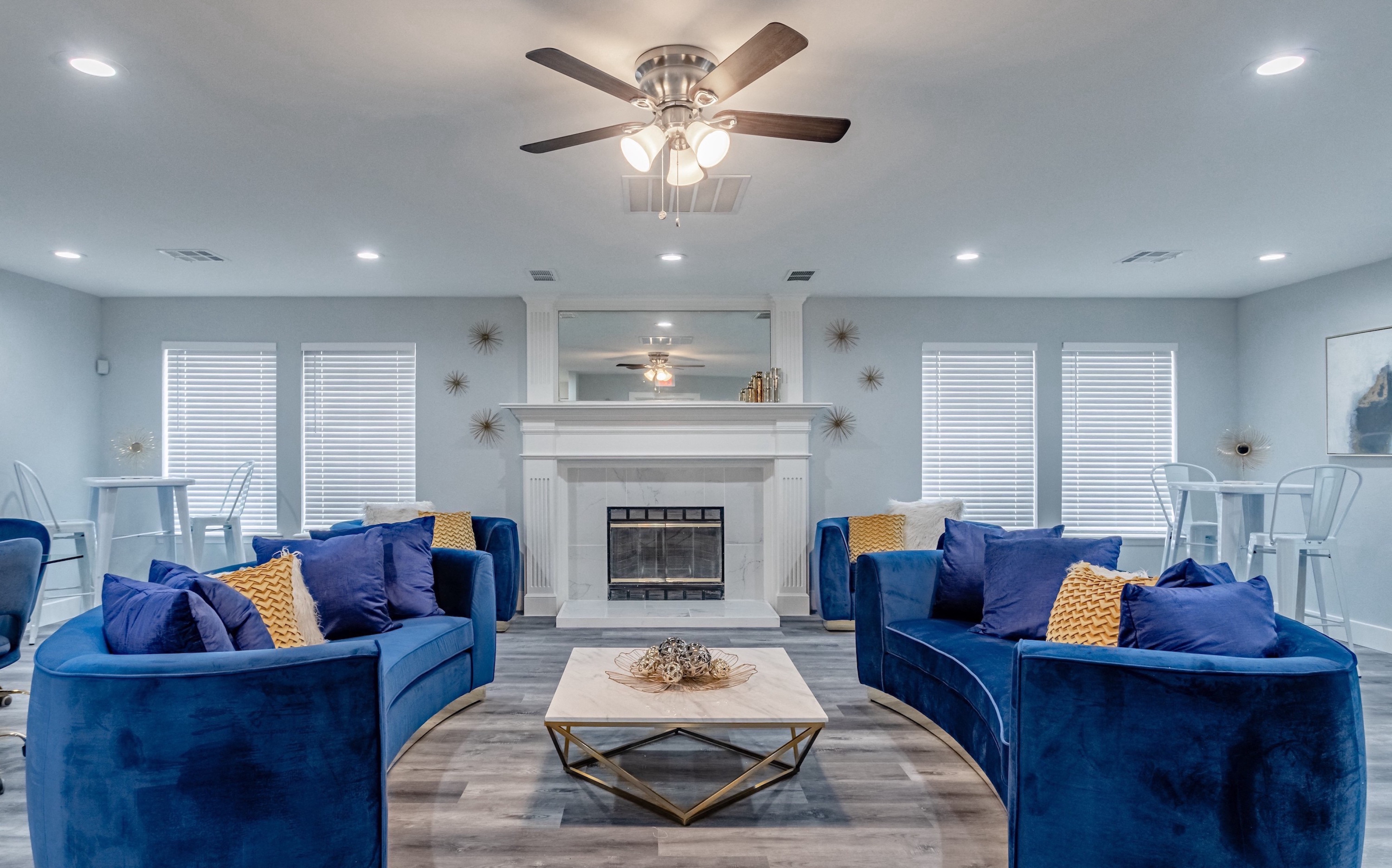 a living room with blue couches and a fireplace